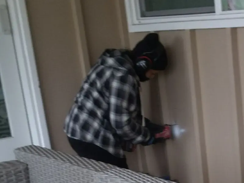 Professional electrician installing an exterior outlet in Granby